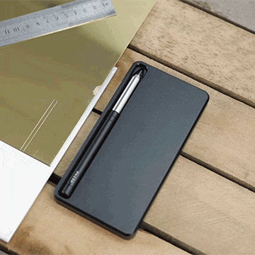 Person writing on the MetMo Multi Drive Metal Case using the MetMo Multi Drive tool with lead attachment.