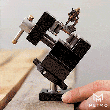 MetMo vise ball joint holding a small figurine gif showing quick release and easy mobility of joint 