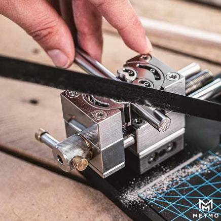 MetMo fractal vice used to saw metal rod with device mounted onto quick release and desktop workstation image