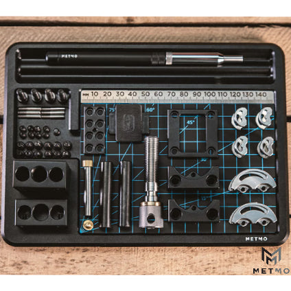 metmo desktop workstation image with disassembled fractal vice arranged across mat and tray