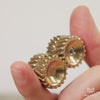 Brass helico being rolled between fingers