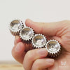Four silver metal helico in different fidget formations - a line, a spinner, wiggling, wheels