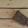 Leather pouch on a wooden background opening up, a hand comes in and takes a silver pocket grip out of the pouch. 