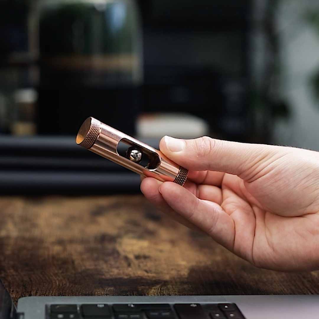 Metmo Eddy science desk toy showing a magnetic ball falling through the copper tube, creating an eddy current 