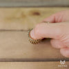 Slo-mo video of brass helico fidget toy spinning 
