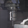 Different shots of a machine shop. Close up CNC machining of silver metal parts. 