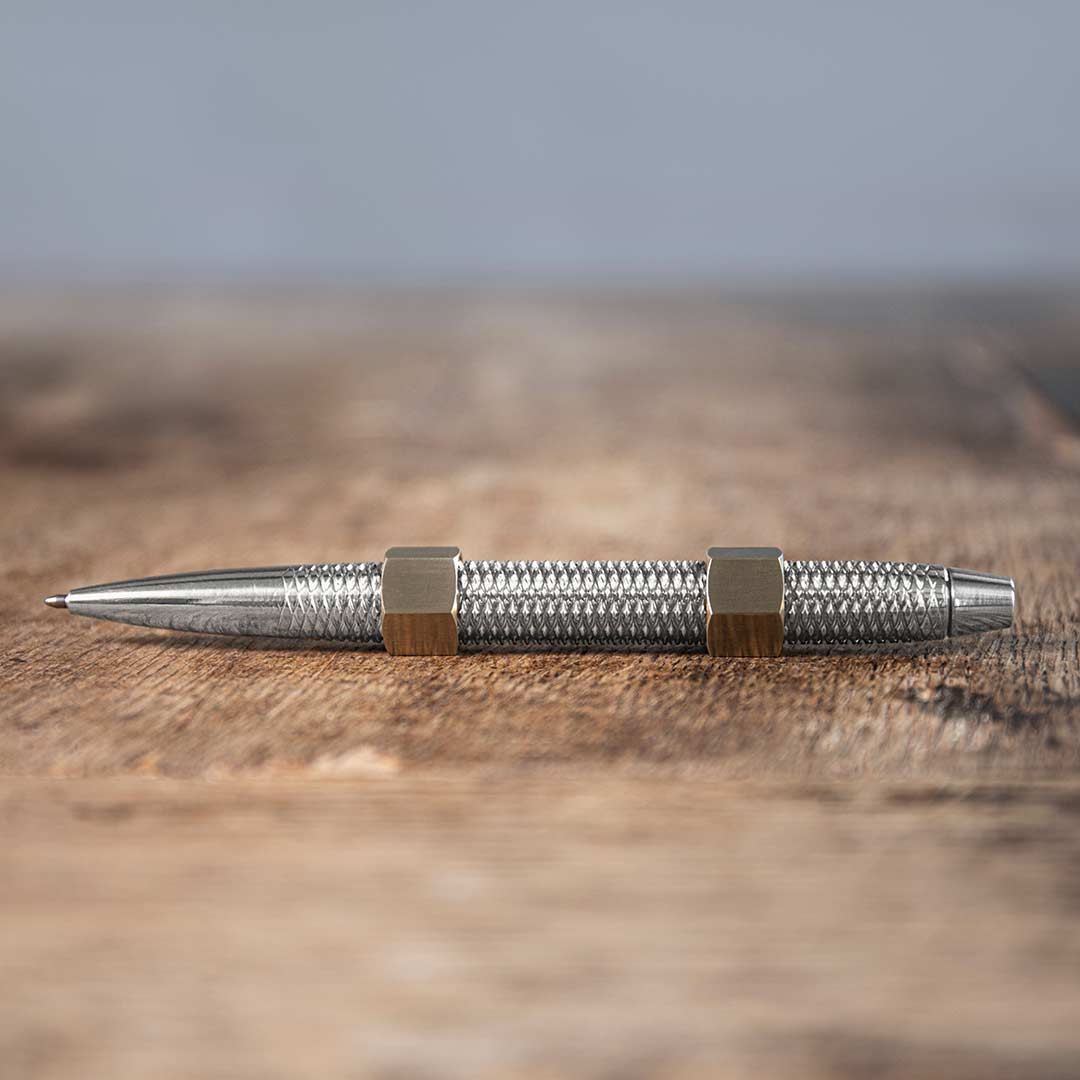 MetMo Aluminium Dual threaded Pen with Brass Nuts on a desk
