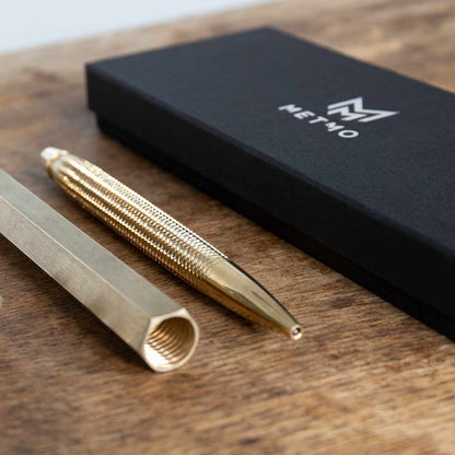 Brass MetMo pen & pen case set alongside its packaging. 