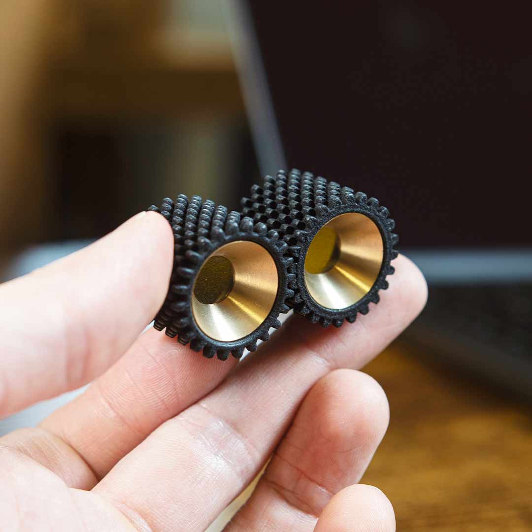 Helico MK2 executive desk toy held in a hand